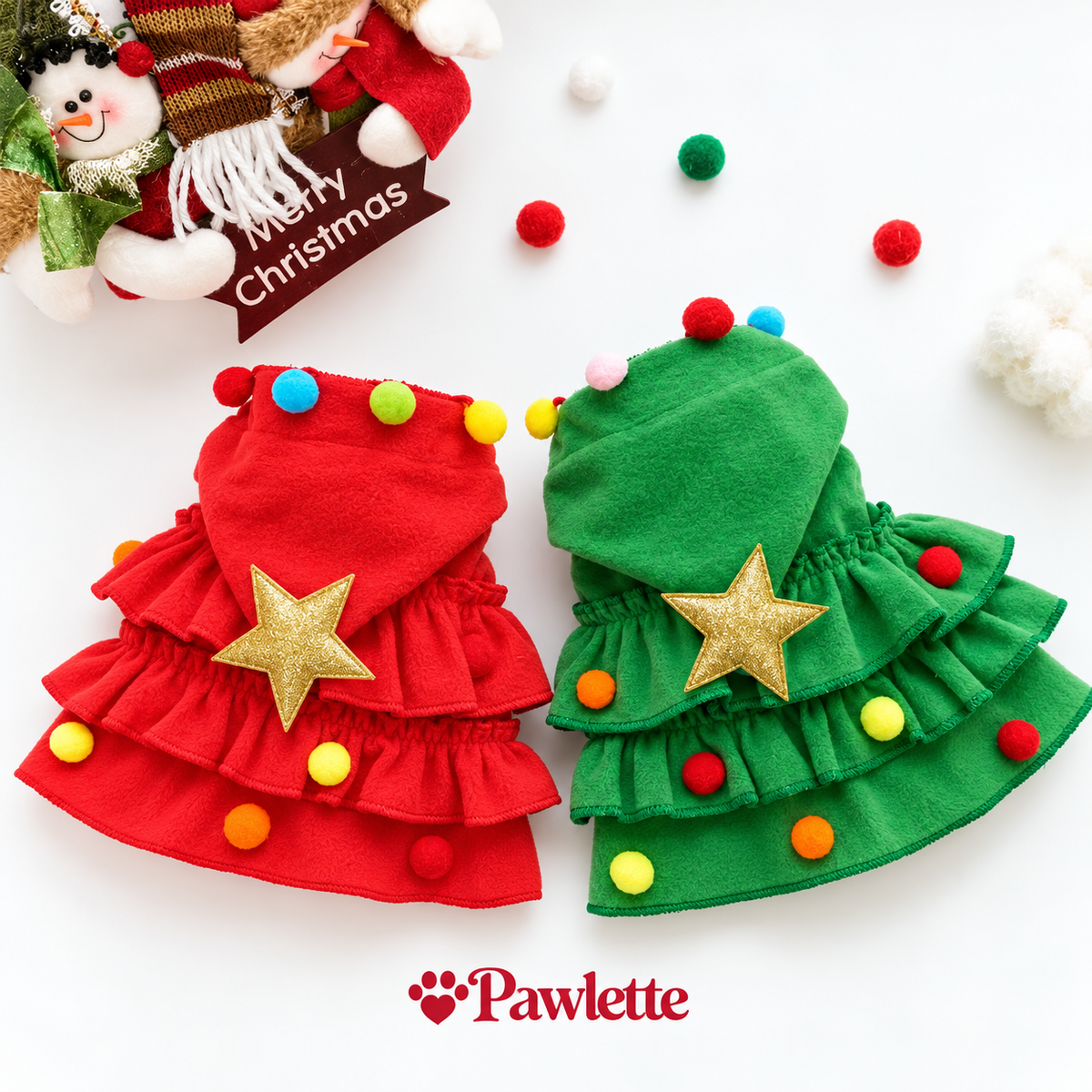 Small dog wearing the Christmas tree costume with star hood and pom-poms